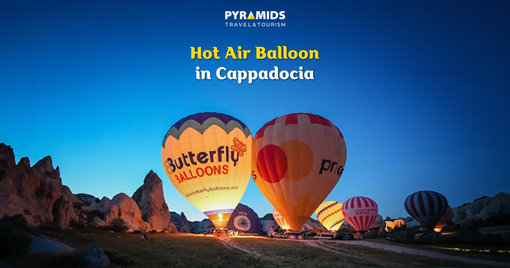 Hot air balloons in Cappadocia, Turkey, preparing for takeoff at sunrise.