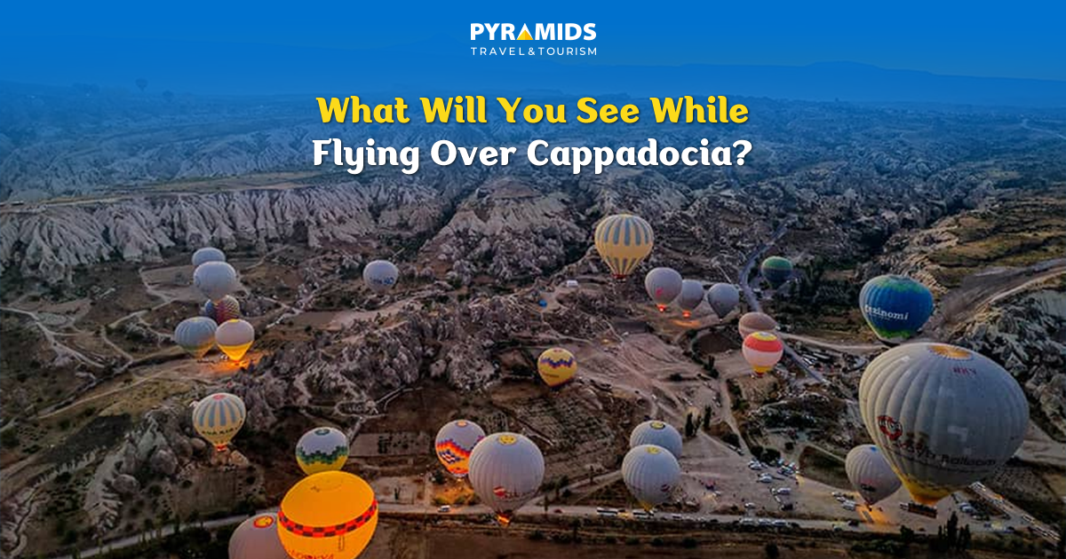 An aerial view of dozens of hot air balloons flying over the valleys of Cappadocia