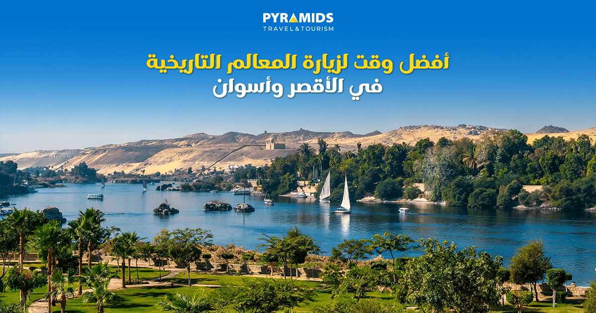  منظر طبيعي لنهر النيل في أسوان مع مراكب شراعية وجزر خضراء وخلفية صحراوية، يعبر عن أفضل وقت لزيارة المعالم التاريخية في الأقصر وأسوان.